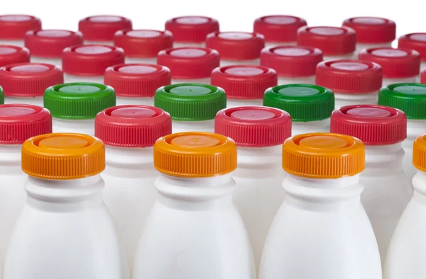 Dairy products bottles with bright covers — Stock Photo, Image