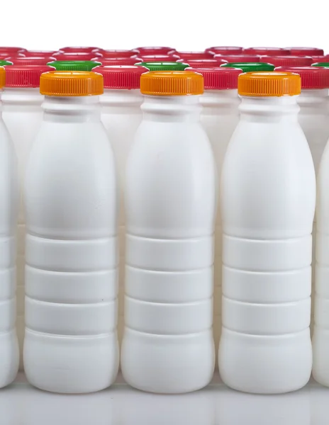 Dairy products bottles with bright covers — Stock Photo, Image