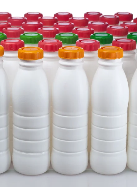 Dairy products bottles with bright covers — Stock Photo, Image