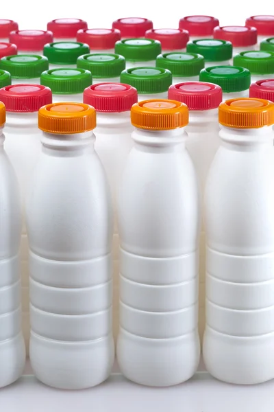 Dairy products bottles with bright covers — Stock Photo, Image