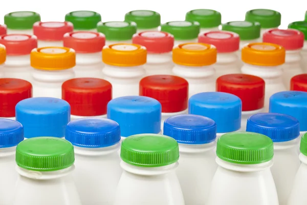 Dairy products bottles with bright covers — Stock Photo, Image