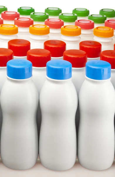 Dairy products bottles with bright covers — Stock Photo, Image