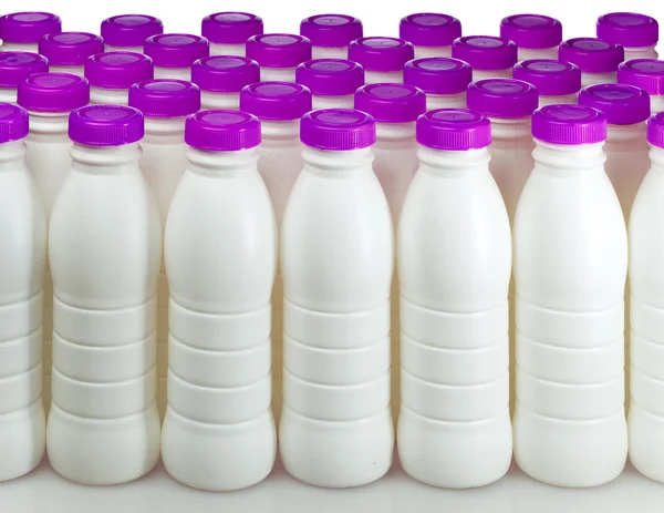Dairy products bottles with bright covers — Stock Photo, Image