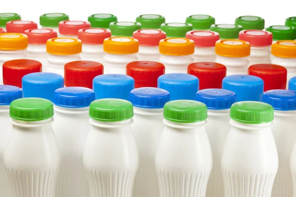 Dairy products bottles with bright covers — Stock Photo, Image