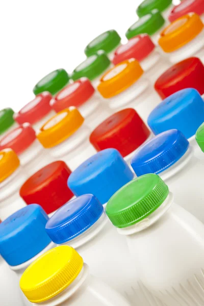 Dairy products bottles with bright covers — Stock Photo, Image