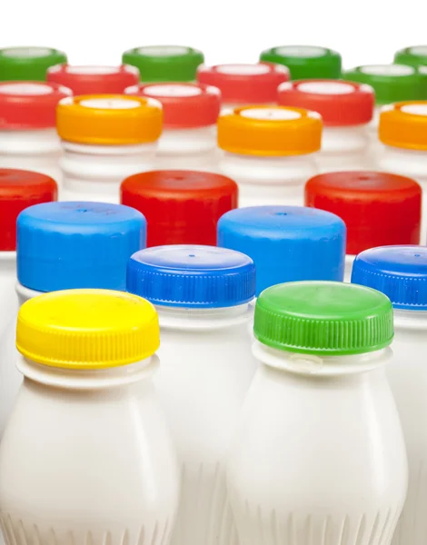 Dairy products bottles with bright covers — Stock Photo, Image