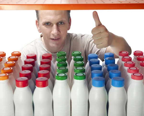 The man selects dairy products in the shop — Stock Photo, Image