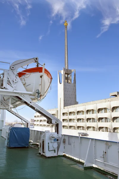 Blick von Bord eines Schiffes auf den Bau einer Marinestation (Seehafen) im Hafen und ein Rettungsboot im Vordergrund. St. Petersburg, Russland — Stockfoto