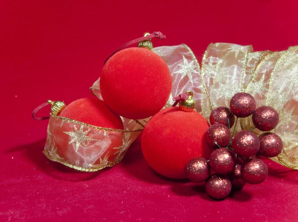 New Year's composition on a red background - ball and ribbon — Stock Photo, Image