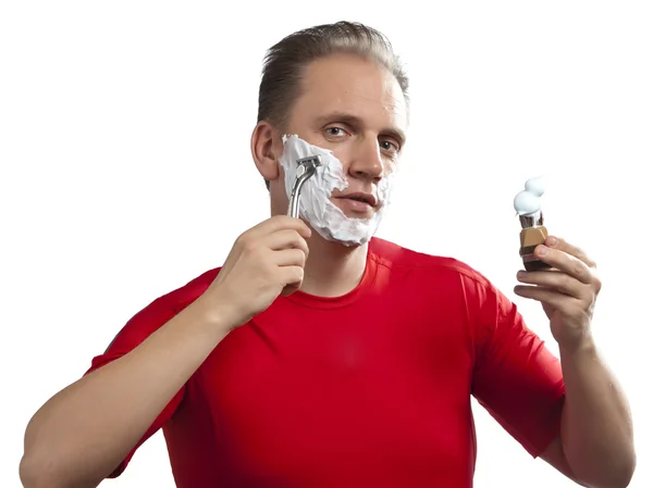 Man has a shave- with the razor and a small brush — Stock Photo, Image