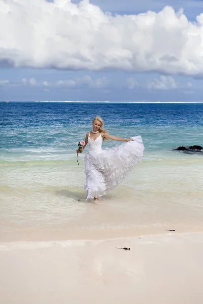 Όμορφη γυναίκα σε ένα γαμήλιο φόρεμα στη θάλασσα — Φωτογραφία Αρχείου
