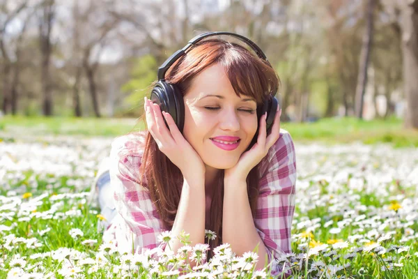 Vrouw die muziek buiten luistert — Stockfoto