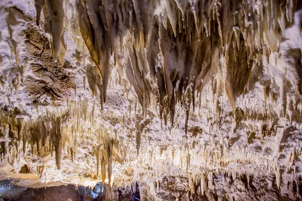 Underground cave, amazing scene , view of stalactites and stalagmite under ground , formation inside.