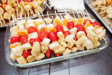 Fruit mix sticks, birthday or wedding party catering, serving on table.