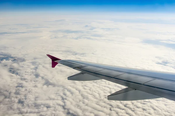 Fluffy clouds and airplane wing — Stock Photo, Image