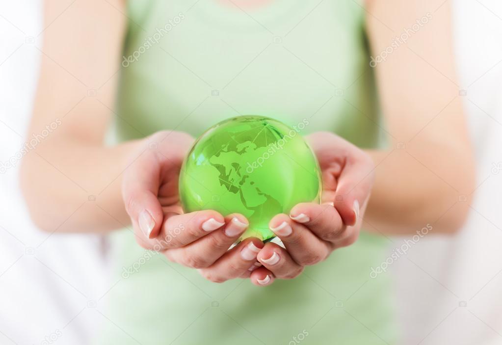 Green Earth Globe in Human Hands 