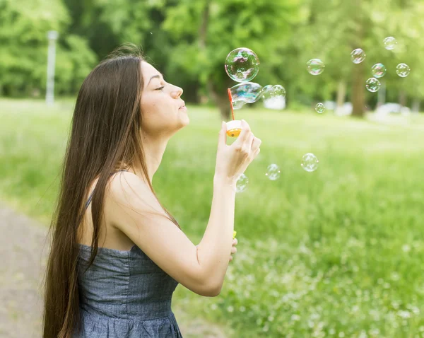 Ung kvinna blåser bubblor — Stockfoto