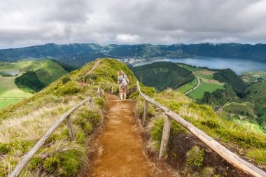 Walking path leading to a view on the lakes of Sete Cidades and clipart
