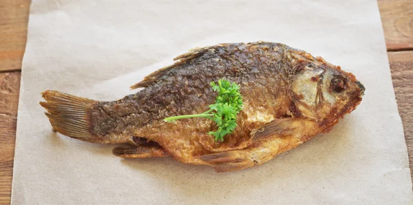 Fried fish on paper — Stock Photo, Image