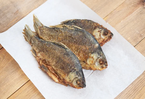 Fried fish on paper — Stock Photo, Image