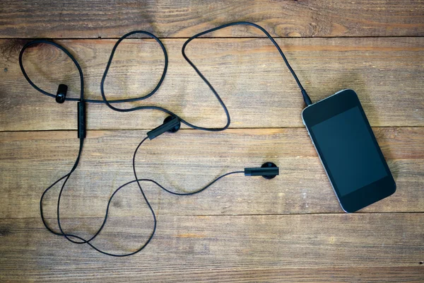 Telefone inteligente e fones de ouvido — Fotografia de Stock