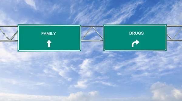 Road signs to family and drugs — Stock Photo, Image