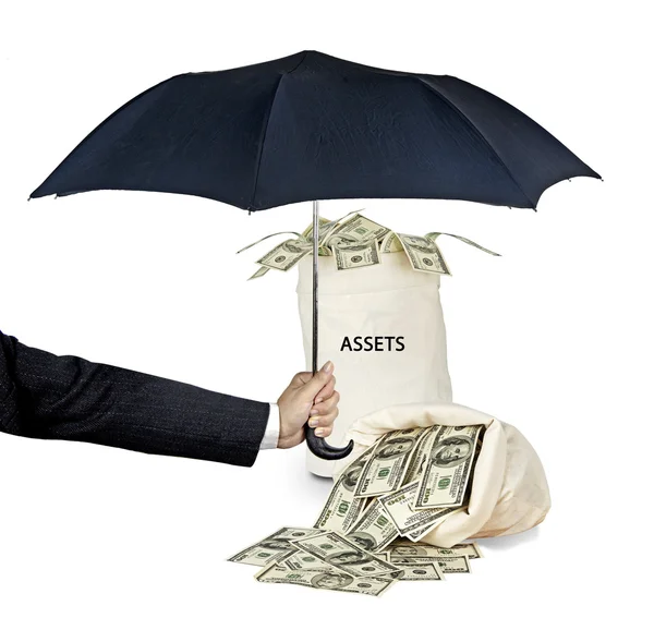 Umbrella protecting assets — Stock Photo, Image