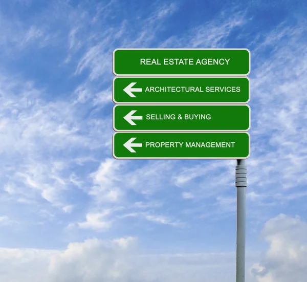 Road sign to real estate agency — Stock Photo, Image