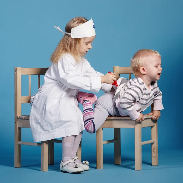 Two cute little girls playing doctor — Stock Photo, Image