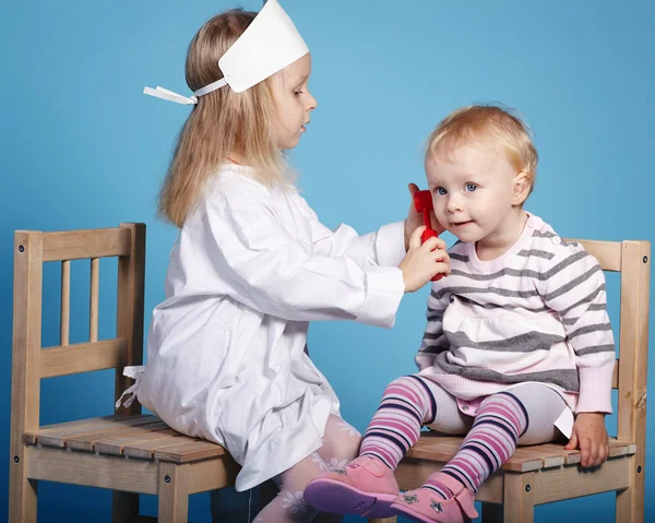 Two cute little girls playing doctor — Stock Photo, Image