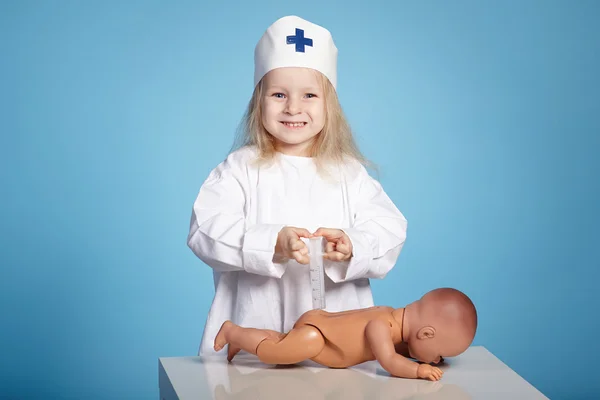 Little funny girl playing nurse — Stock Photo, Image