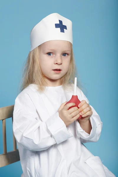 Little funny girl playing nurse — Stock Photo, Image
