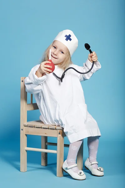 Little funny girl playing nurse — Stock Photo, Image