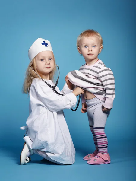 Two cute little girls playing doctor — Stock Photo, Image