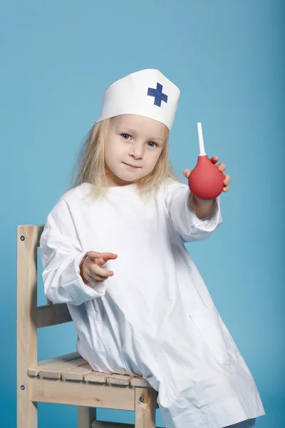 Little funny girl playing nurse — Stock Photo, Image