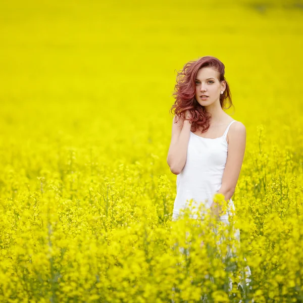 Young beautiful girl in yellow field — Stock Photo, Image