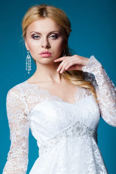 Beautiful bride in wedding dress on blue — Stock Photo, Image