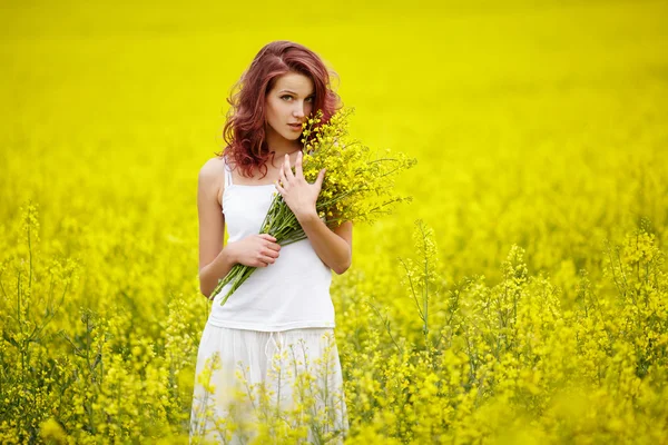 Giovane bella ragazza in campo giallo — Foto Stock