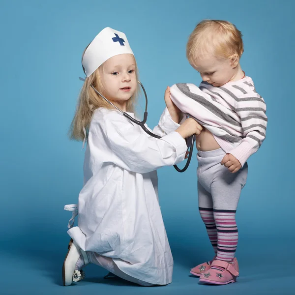 Two cute little girls playing doctor — Stock Photo, Image