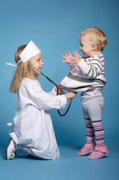 Two cute little girls playing doctor — Stock Photo, Image