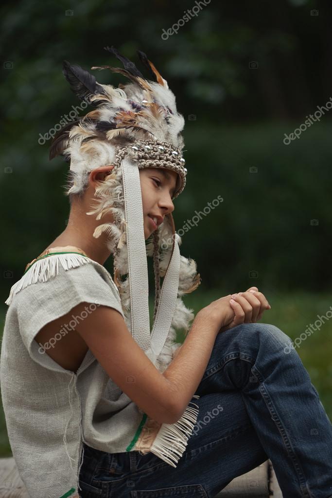 Little funny boy playing native american Stock Photo by ©ababaka 108219026