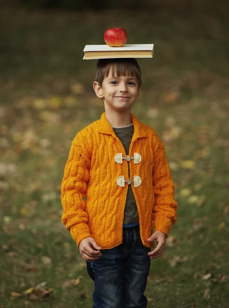 Funny boy med boken på huvudet — Stockfoto