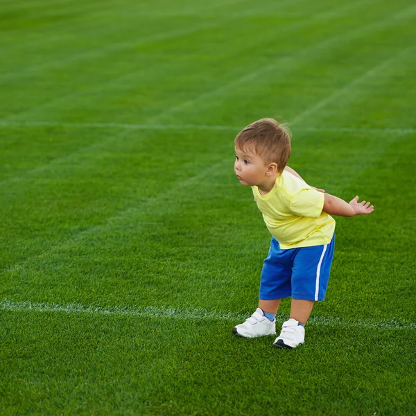 Little funny boy on football field — Stock Photo, Image