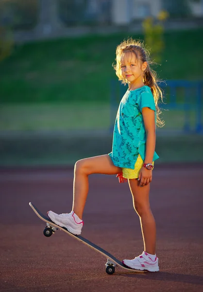 Photo of cute little girl with skateboard outdoors — Stock Photo, Image