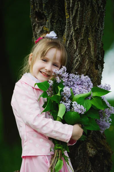Little girl with lilac bouquet — Stock Photo, Image