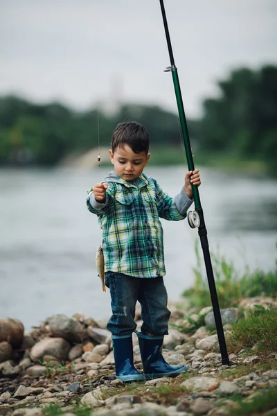 Boy fishing on the coast of river — Stock Photo, Image