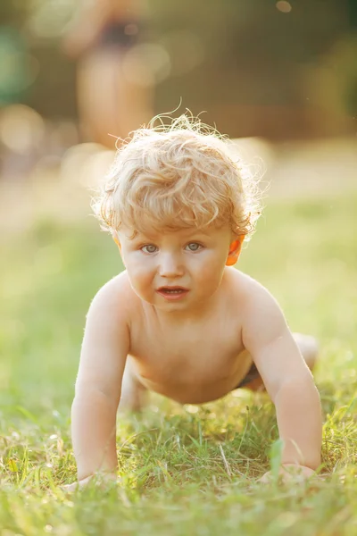Маленький забавный мальчик на траве — стоковое фото