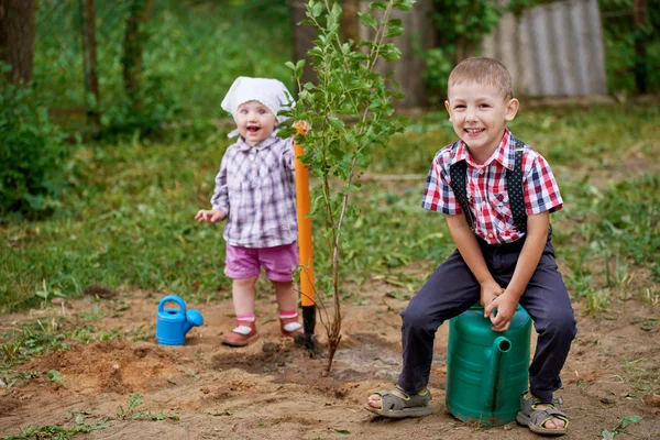 Funny boy with shovel in garden — Stock Photo, Image