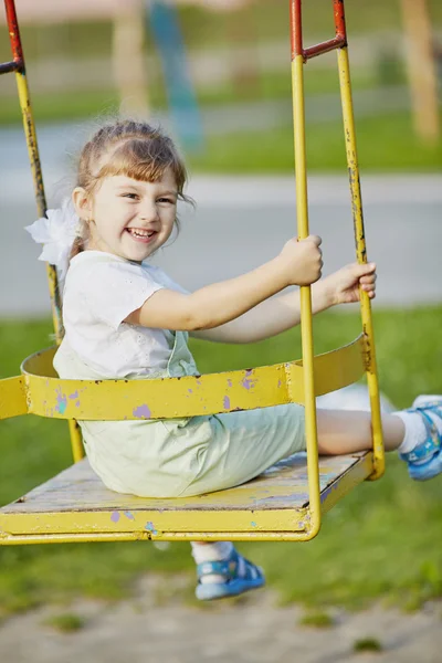 Little happy girl on the swings — Stock Photo, Image