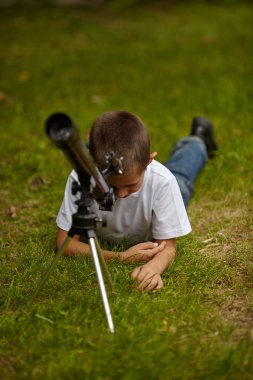 happy little boy with telescope clipart